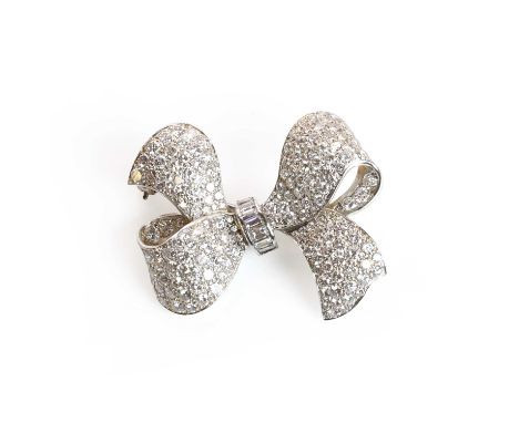 A mid-20th century diamond ribbon bow brooch,  the stylised ribbon bow pavé set throughout with graduated round brilliant dia