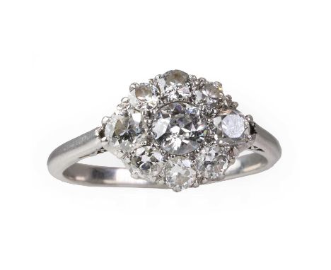 A platinum and diamond cluster ring, c.1920,  centring on an old European diamond encircled by graduated old European and tra