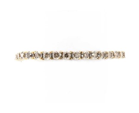 A diamond set line bracelet, probably American, with a row of thirty four brilliant cut diamonds, probably fancy brown, fancy