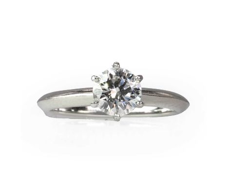 A platinum diamond single stone ring, by Tiffany & Co.,  with a round brilliant cut diamond, stated weight 0.80ct, in a six c