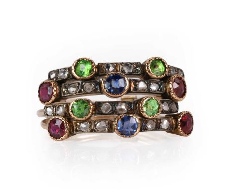 An Edwardian demantoid garnet, ruby, sapphire, and diamond Harem ring, c.1905,   two bands with a central mixed cut sapphire 