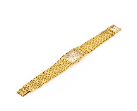 An 18ct gold Omega mechanical bracelet watch,  a rectangular champagne dial with enamelled gilt baton indicators and pencil h