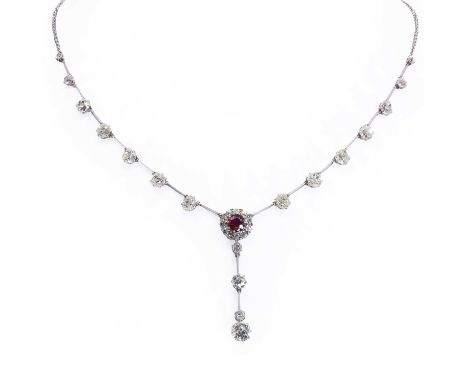 A diamond and ruby necklace, c.1915, with a central ruby and diamond cluster suspending a diamond knife edge drop, terminatin