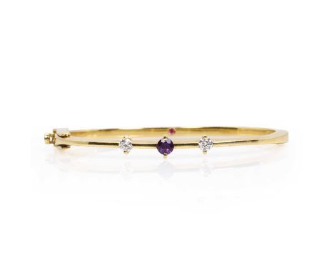 An amethyst and diamond 'Parisienne' bangle, by Roberto Coin,  with a circular cut amethyst flanked by a round brilliant cut 