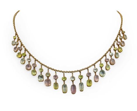 An Edwardian pink topaz, aquamarine and chrysolite fringe necklace, c.1905, a series of graduated fringes claw set with pink 