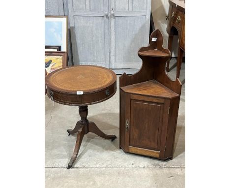 A mahogany drum occasional table and an oak hanging corner cupboard