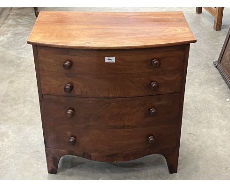 A 19th century mahogany commode in the form of a bowfronted chest of drawers. 26' wide