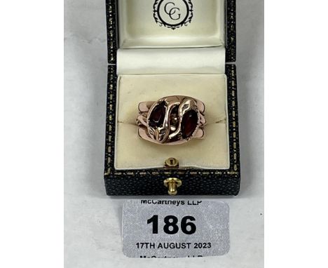 An antique gentleman's gypsy set garnet and diamond snake ring. In gold. The pear shaped garnets 10mm long approx. 11g gross.