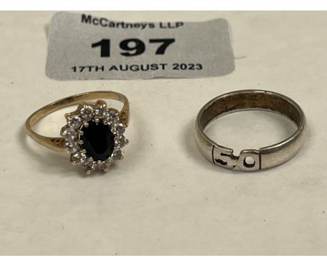 A 9ct sapphire and white stone cluster ring and a silver wedding ring. The gold ring 2g gross