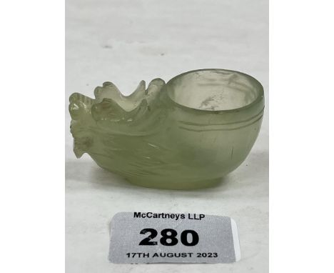 A Chinese carved jade dragon ink pot. 2½' long