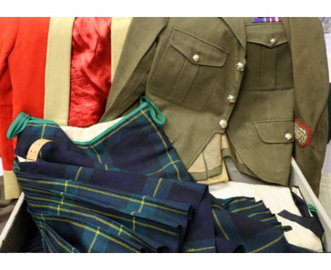 Gordon Highlanders dress including three kilts, brogues, tunic etc., within a canvas trunk.