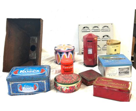 A collection of advertising tins with iron dam pipe and a room in and out indicator. 