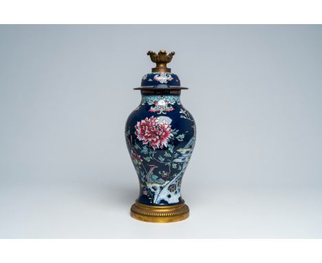 Full title: A Chinese famille rose blue ground vase mounted as a lamp, 19th C.Description:H 58 cm (incl. the mounts) The abse