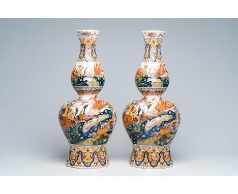 Full title: A pair of large Boch FrÃ¨res Keramis double gourd vases in Delft style with birds and insects among blossoming br