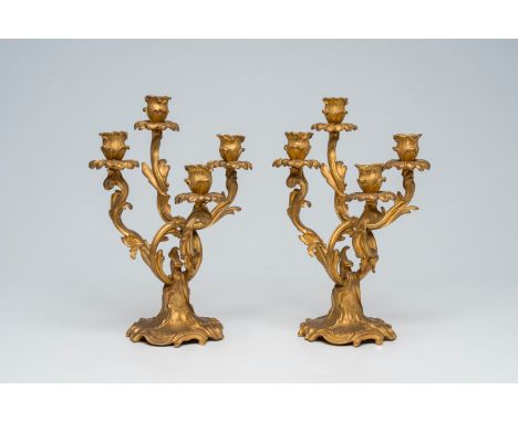 Full title: A pair of French Louis XV style gilt bronze four-light candelabra, 19th/20th C.Description:H 37 cm The absence of