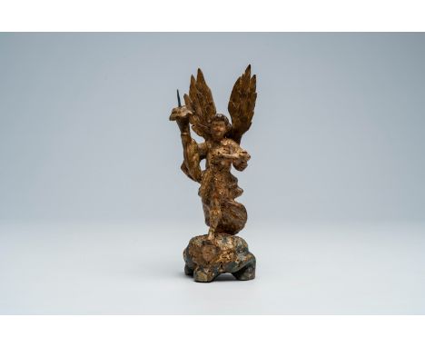 Full title: An Italian carved, polychrome painted and gilt wood archangel Michael shaped candlestick, 17th C.Description:H 24