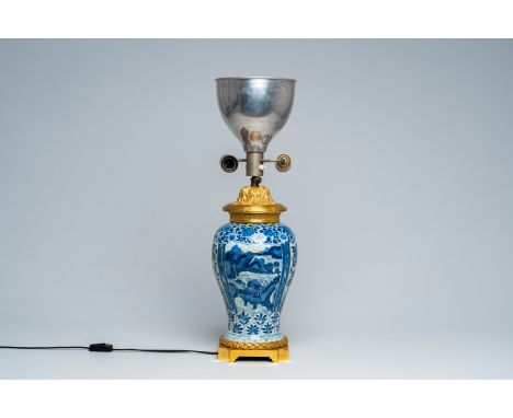 Full title: A Chinese blue and white vase with gilt bronze lamp mounts, KangxiDescription:H 66,1 cm (incl. the mounts) The ab