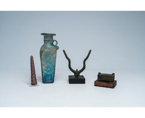Full title: A varied collection of archaeological finds and a blue glass bottle with glass thread design, possibly Roman peri