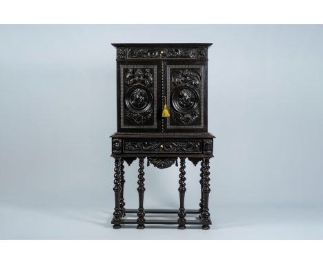 Full title: An ebonised wood two-door cabinet on stand with portrait medallions, 19th C.Description:H 169,5 - L 97 - D 51 cm 