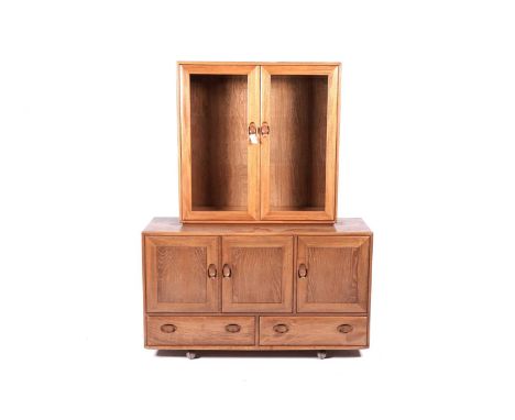 Lucian Ercolani for Ercol: an elm and beech sideboard with three doors above two drawers, with glazed two door cabinet top, 1