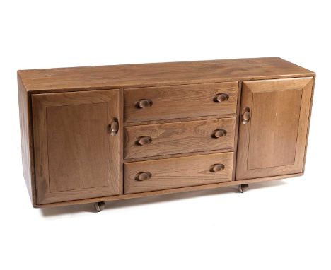 Lucian Ercolani for Ercol: a 'Windsor' model 455 elm and beech sideboard, with bank of three drawers flanked by two cupboard 