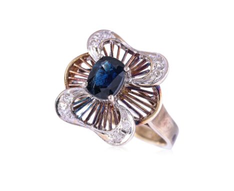 A SAPPHIRE AND DIAMOND RING
Featuring a cushion cut sapphire weighing approximately 0.70 Cts, mounted in a mixed gold setting