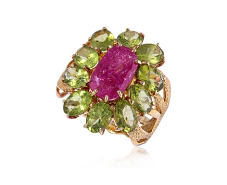 A RUBY AND PERIDOT RING Featuring a cushion cut ruby weighing approximately 4.0 Cts, mounted in an unmarked yellow gold setti