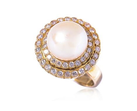 A CULTURED PEARL AND DIAMOND RING
Featuring a button shaped cultured pearl measuring approximately 10.9mm, mounted in a yello