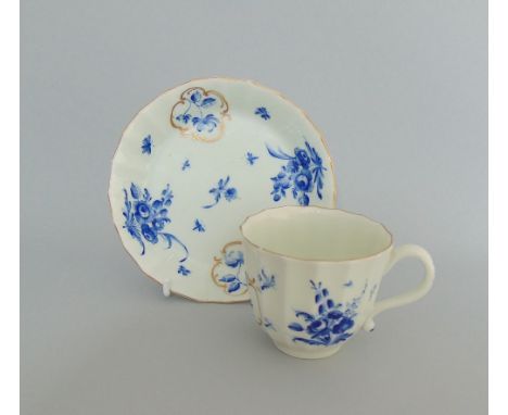 A  Worcester faceted coffee cup and saucer, painted with 'dry blue' and gilt mirror panels, circa 1765, fret mark, cup     6.