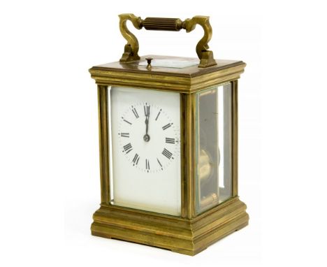 An early 20th Century French repeating carriage clock, brass corniche case with visible escapement, white enamel Roman dial, 