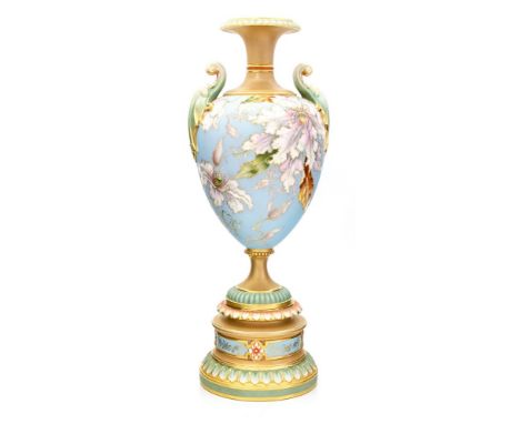 A Royal Worcester matte glazed pedestal vase, 1898, twin handled ovoid form with clematis decoration on a pale blue ground, h