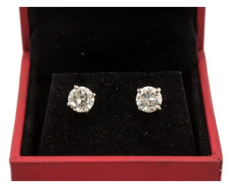 A pair of diamond solitaire 18ct white gold stud earrings, screw back pierced ear fittings, the two round brilliant cut diamo