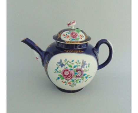A Worcester tea pot and cover, painted with flowers  on a wet blue ground, circa 1768-72, 18cm high including cover Condition