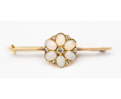A high carat gold (probably 18ct) opal and diamond bar brooch, with a flower detail to the centre, set with six oval opals an