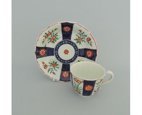 A Worcester cup and saucer, decorated in 'The Queens' pattern from the red line group, circa 1770, fret mark, cup 6.6cm diame