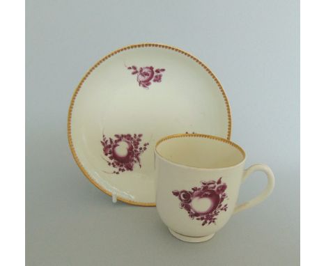 A rare Worcester coffee cup and saucer, painted with fruit in purple monochrome, circa 1770-72, cup 6cm diameter, 6.5c high, 
