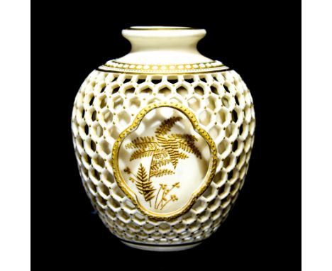 George Owen for Royal Worcester, a blush ivory double walled reticulated vase, jewelled and raised gilt decoration of ferns, 