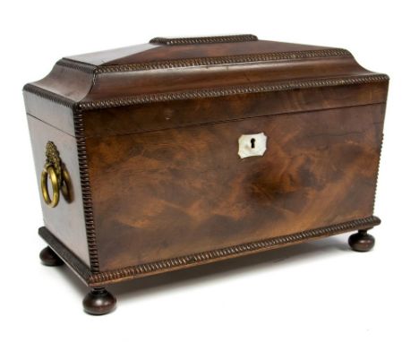 A Regency mahogany tea caddy, circa 1820's, of sarcophagus form with gadroon detailing, triple division interior with twin li