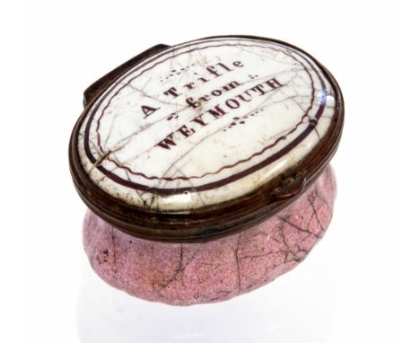An 18th Century Bilston enamel oval patch box, circa 1780, the cover with motto 'A Trifle from Weymouth', mirrored inner cove