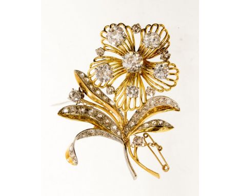A circa 1950s stylised diamond spray brooch, the open wirework flower head set with eleven round and cushion shaped old cut d