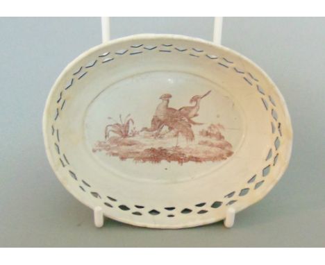An English enamel small oval dish with pierced border and a  puce print of birds in the base, circa 1800, 10cm diameter,   3.