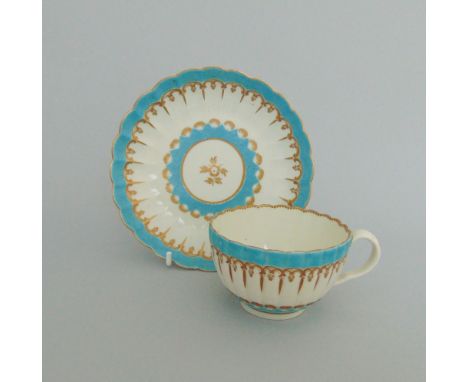 A Worcester 'French' shape tea cup and saucer, decorated with a bright turquoise enamel and gilt borders, circa 1775, cup 7.2