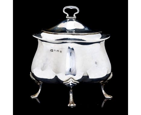 An Edward VII silver tea caddy, plain quatrefoil and bombe shape raised on four scroll supports with trefoil feet, the domed 