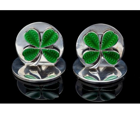 A pair of Edward VII silver menu holders, shaped circular with green enamel four leaf clover decoration, Sampson Morden, Ches