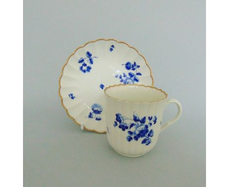 A Worcester fluted coffee cup and saucer, decorated in 'The Giles' manner with 'dry blue' flowers, circa 1780, cup 6.5cm high