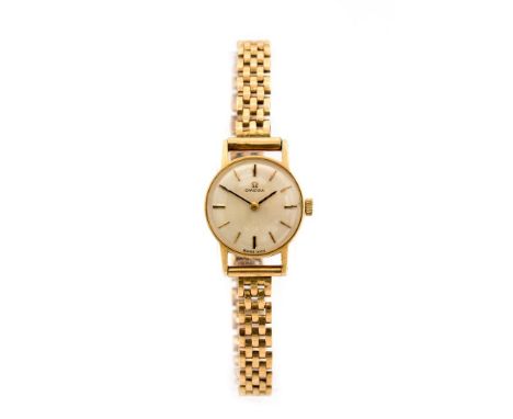 Omega, a circa 1960's ladies 9ct gold Omega wristwatch, 1.5cm circular champagne dial with baton numerals, integral 9ct gold 