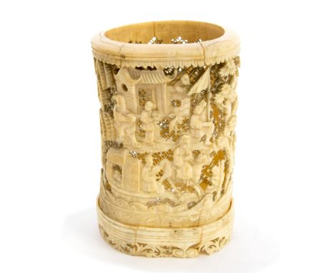 A 19th century or earlier Chinese carved ivory brush pot, reticulated lattice ground with figures in relief, 17cm high 