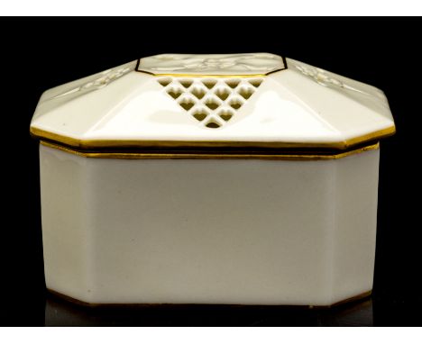 George Owen for Royal Worcester, a reticulated covered box, 1913, elongated octagonal section, the domed and chamfered lid pi