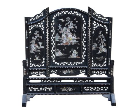 An early 20th Century Chinese ebonised firescreen, triple fret panels with inlaid mother of pearl to form pagoda landscapes w