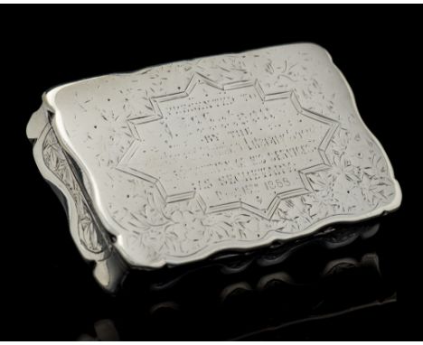 A Victorian silver snuff box, shaped oblong the body engraved with stylised Chinoiserie foliage, the cover with a presentatio